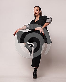 confident woman in elegant black suit with studio fashion portrait