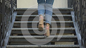 Confident woman in high heels climbing up stairs, career growth, way to dream