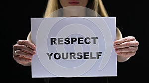 Confident woman holding respect yourself sign, acceptation of own personality