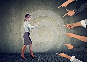 Confident woman keeping hands in stop gesture, trying to defend herself photo