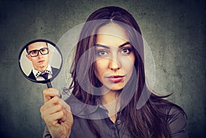 Confident woman posing with magnifier