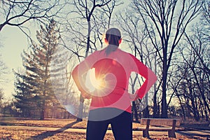 Confident woman preparing for a morning run outdoors in a park