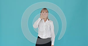 Confident Woman Silencing Herself with Palm on Blue Background