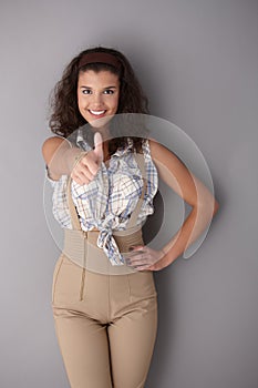 Confident woman smiling with thumb up