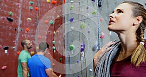 Confident woman standing with rope in fitness studio 4k