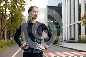 Confident woman takes a break from urban running, ready for fitness goals