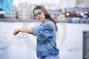 Confident woman wearing sunglasses and Jean jacket
