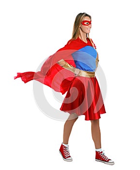 Confident woman wearing superhero costume on white background