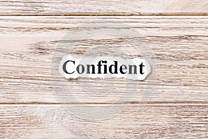 Confident of the word on paper. concept. Words of confident on a wooden background