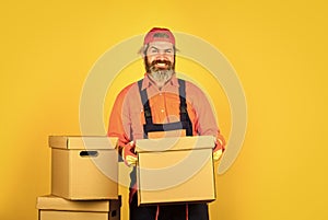 Confident worker. express delivery concept. Man worker in boilersuit at box. moving to new apartment. New Wave of Living