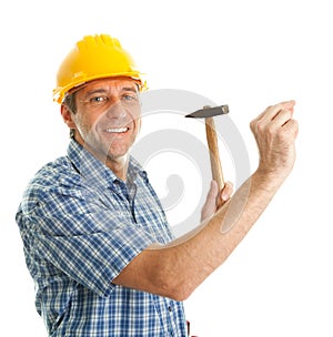 Confident worker hammering in