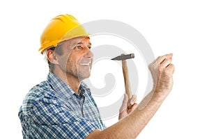 Confident worker hammering in