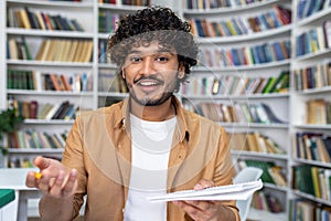 Confident young adult offering advice in a library setting