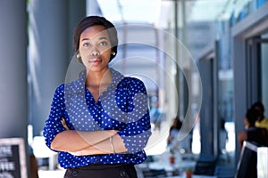 Confident young african american woman standing in the city photo