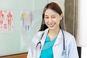 Confident young Asia female doctor in white medical uniform with stethoscope looking at camera and smiling  health hospital.