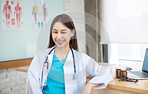 Confident young Asia female doctor in white medical uniform with stethoscope looking at camera and smiling  health hospital.