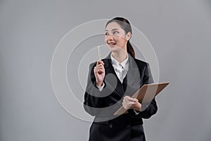 Confident young asian businesswoman in formal suit pointing finger. Enthusiastic