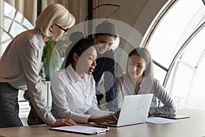 Confident young Asian professional presenting project to coworkers