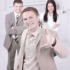 Confident young business man showing thumb up