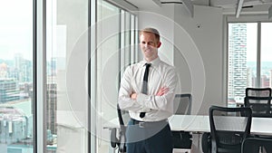 Confident young business man wearing tie standing in office, portrait.