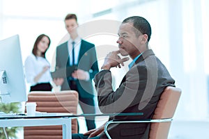 Confident young businessman on blurred background office