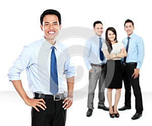 Confident young businessman and business team as background
