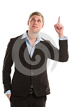 Confident young businessman pointing upwards isolated
