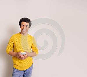 Confident young businessman smiling and using social media over smart phone on white background