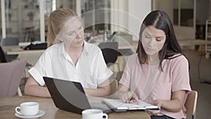 Confident young businesswomen concluding agreement