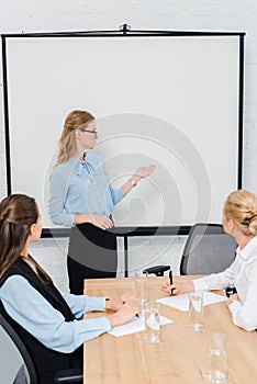 confident young businesswomen listening presentation