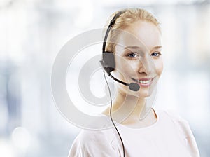 Confident young female customer service agent with headset