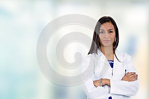 Confident young female doctor medical professional standing in hospital