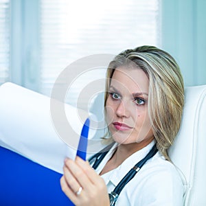 Confident Young Female Doctor Is Reading Results