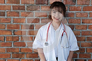 Confident young female doctor smiling at camera. Portrait of m