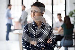 Confident young female of indian ethnicity looking at distance pondering