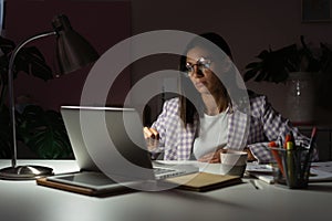 Confident Young Indian Mixed-race Businesswoman Working in Office at Night. Girl Working Overtime