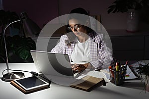 Confident Young Indian Mixed-race Businesswoman Working in Office at Night. Girl Working Overtime