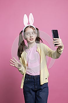 Confident young kid uses phone network to meet on videocall