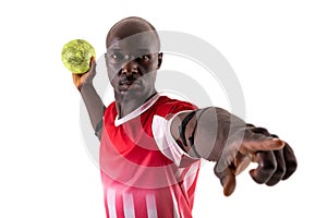 Confident young male african american male handball player throwing ball against white background