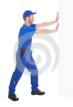 Confident Young Male Cleaner Holding Mop