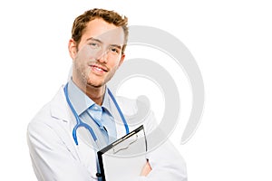 Confident young male doctor holding clipboard on white background
