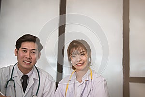 Confident young male & female doctor smiling at camera. Portrai