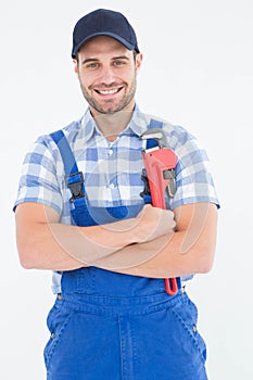 Confident young male repairman holding adjustable spanner