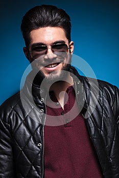 Confident young man with long beard smiling