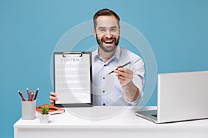 Confident young man in shirt work at desk with pc laptop isolated on pastel blue background. Achievement business career