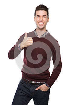 Confident young man smiling with thumbs up sign