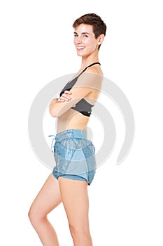 Confident young sports woman smiling against isolated white background