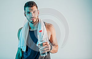 Confident young sportsman hold bottle with water