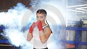 Confident young woman boxer training