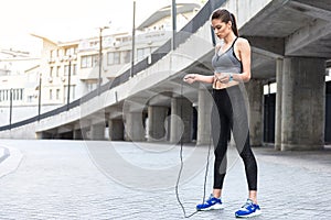 Confident young woman jumping on rope